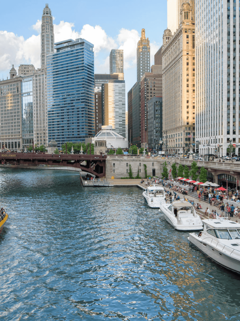 Modern Chicago skyline with boats along the river, showcasing urban beauty and city life.