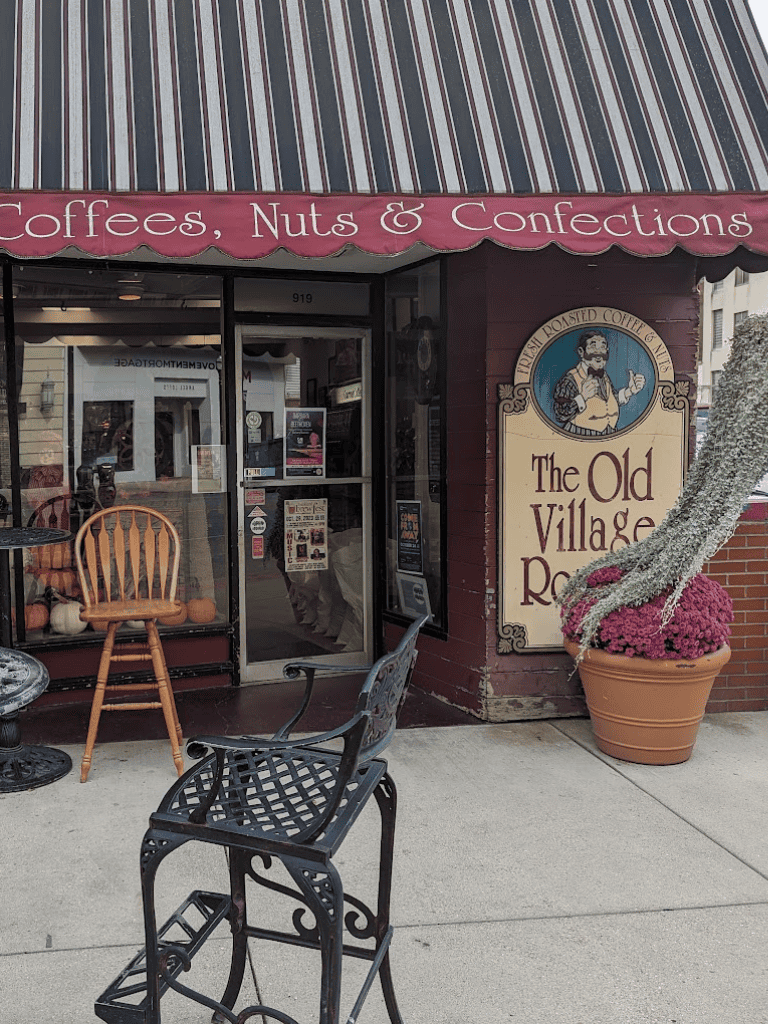 Cozy cafe outdoor seating with vintage decor and potted plants at The Old Village.