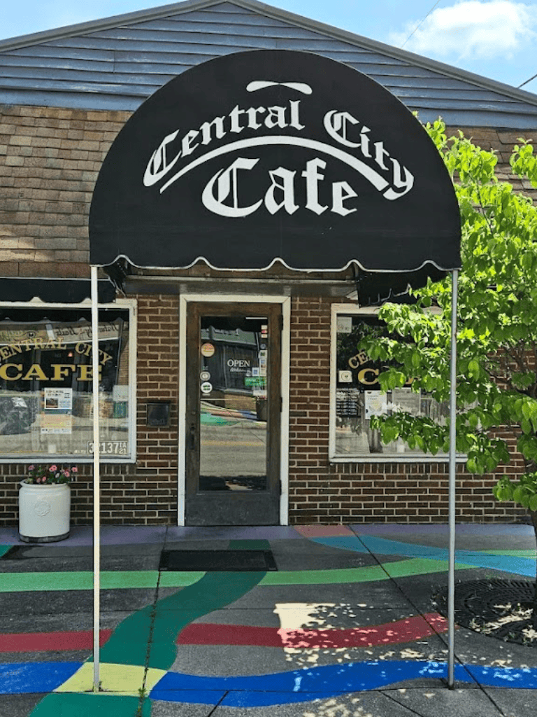 Quiet central city cafe with colorful sidewalk art and welcoming storefront ambiance.