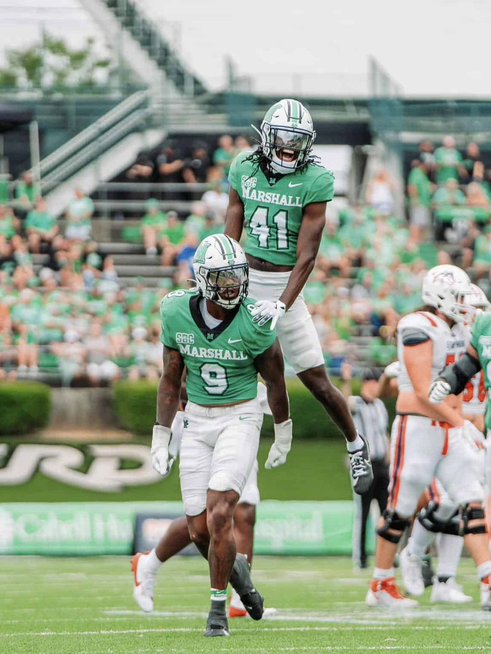 High school football players celebrating touchdown, team Spirit, victory celebration.
