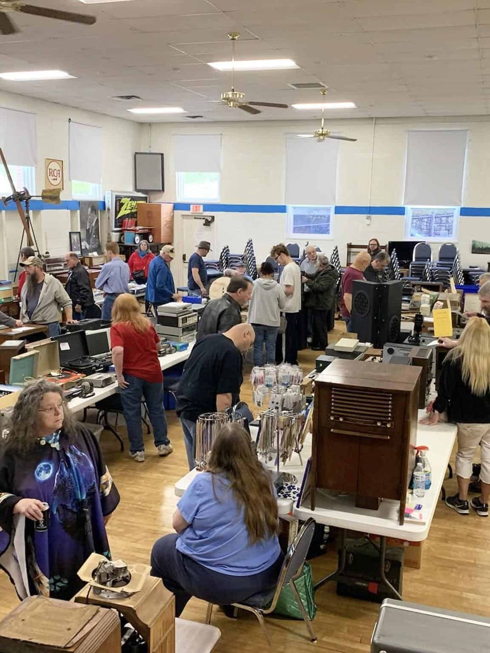 Vintage record auction event at QuestForDirections, featuring diverse collectibles and enthusiastic collectors in a spacious venue.