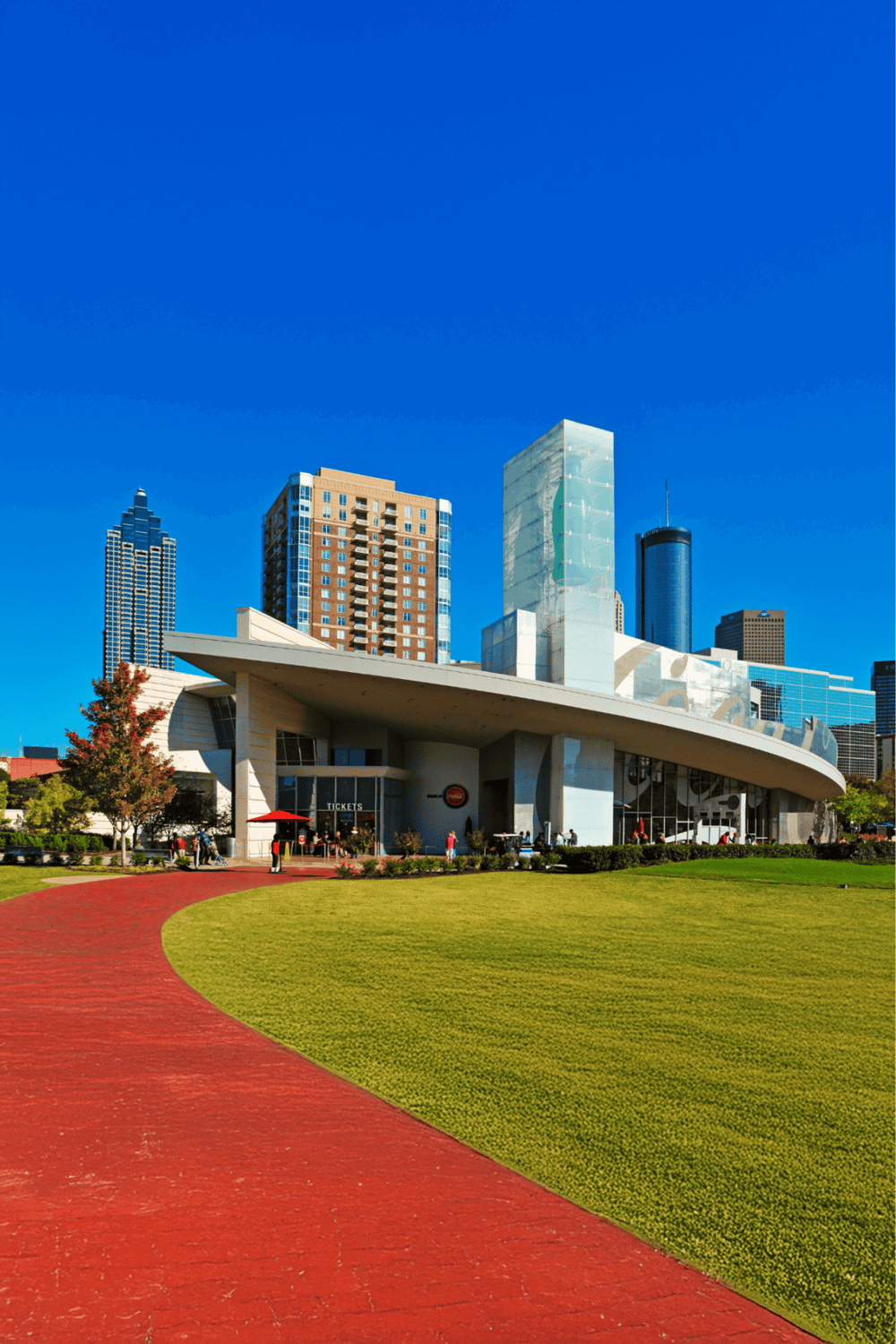 Modern cityscape featuring Quest for Directions event venue in downtown with skyscrapers, green park, and clear blue sky.