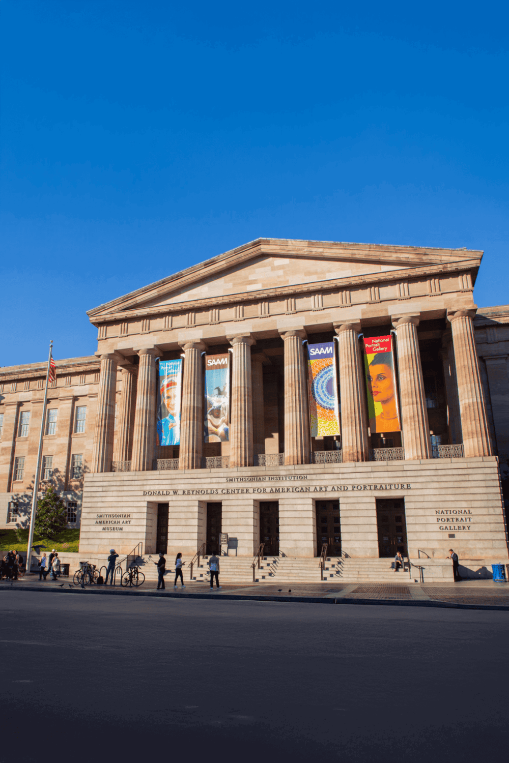 Historic Smithsonian Institution building with grand columns and banners, located in Washington D.C.