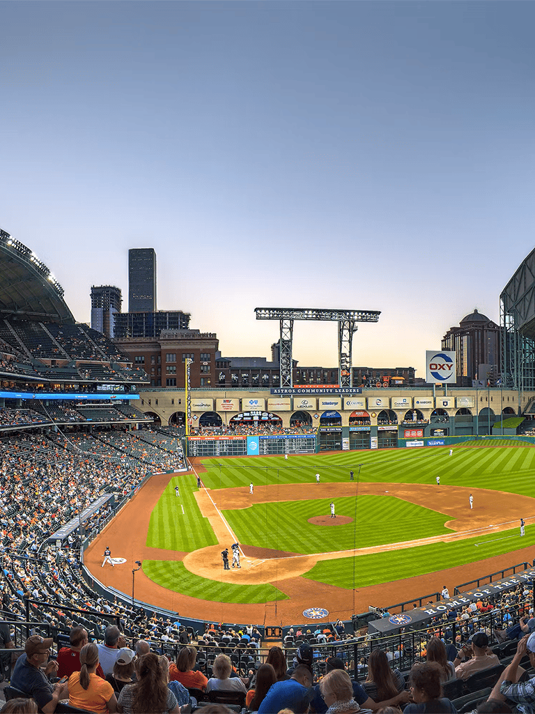 Aerial view of Houston Astros baseball game at Minute Maid Park during sunset.