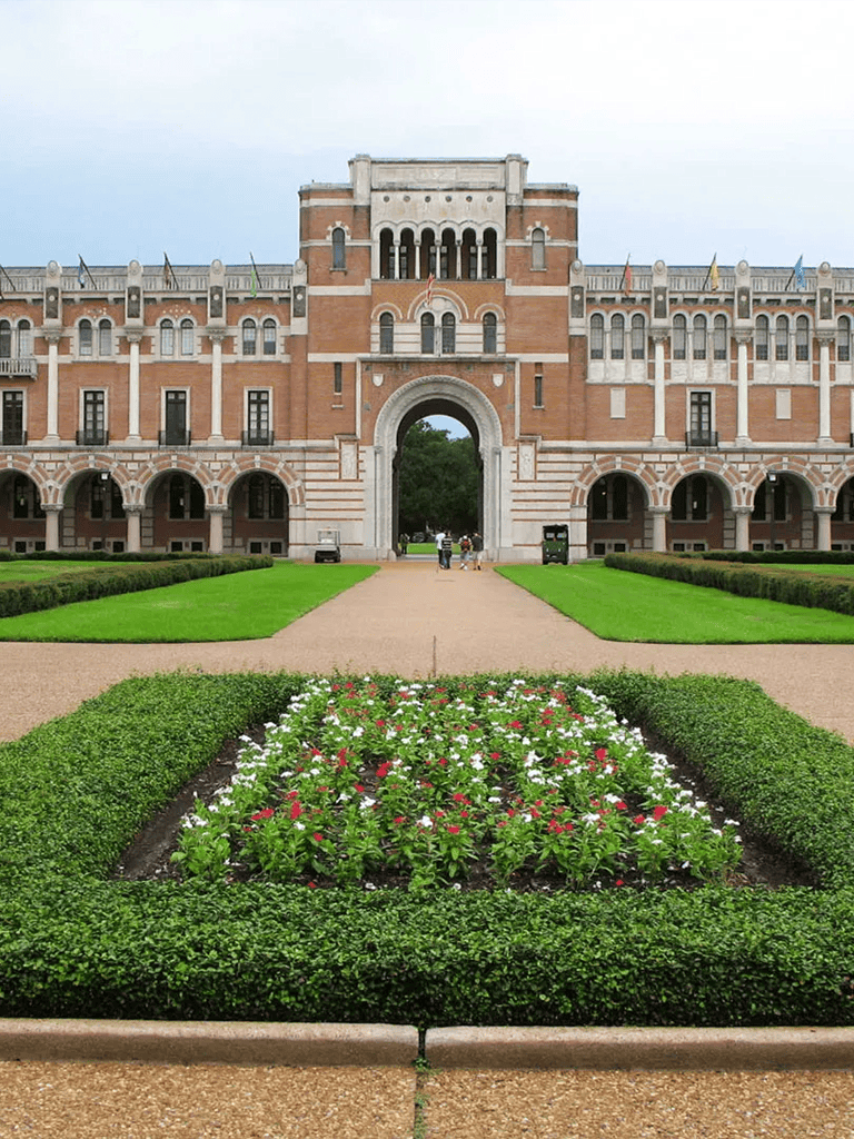 Majestic historic university building with beautiful garden in front, exemplifying educational landmarks and garden beauty.
