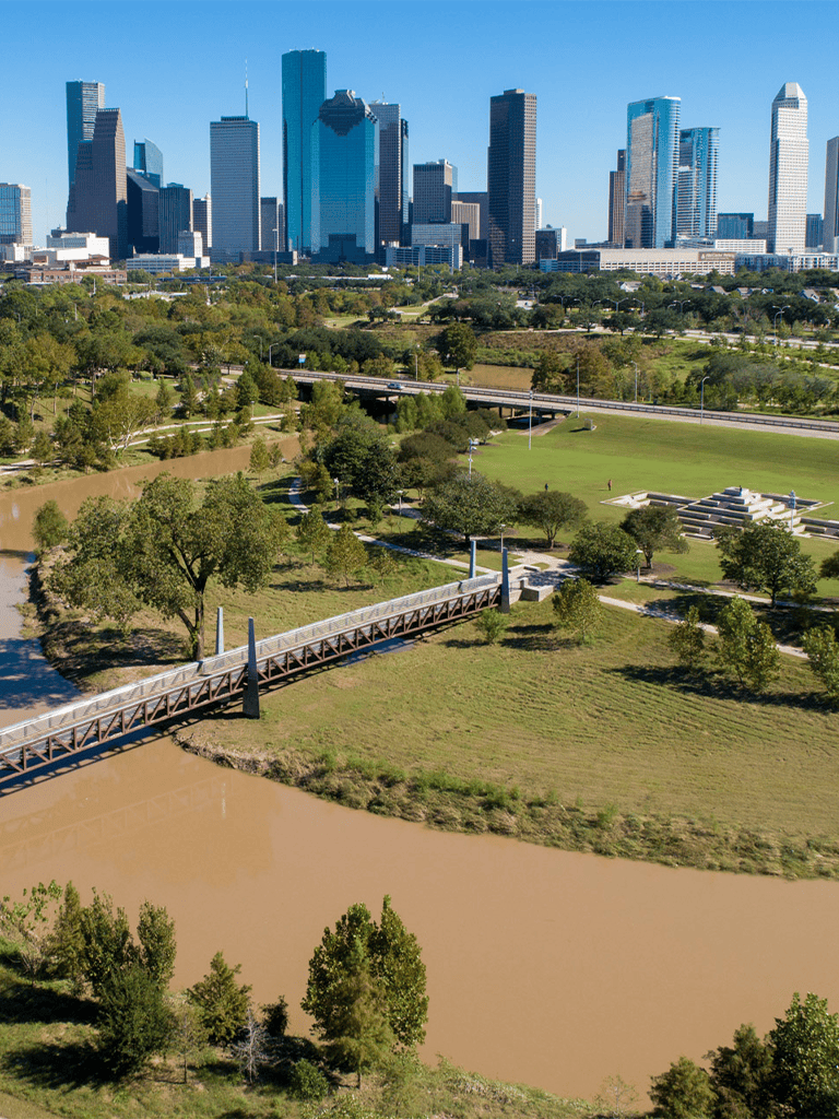 City skyline with downtown skyscrapers and green park with river in Dallas, Texas.