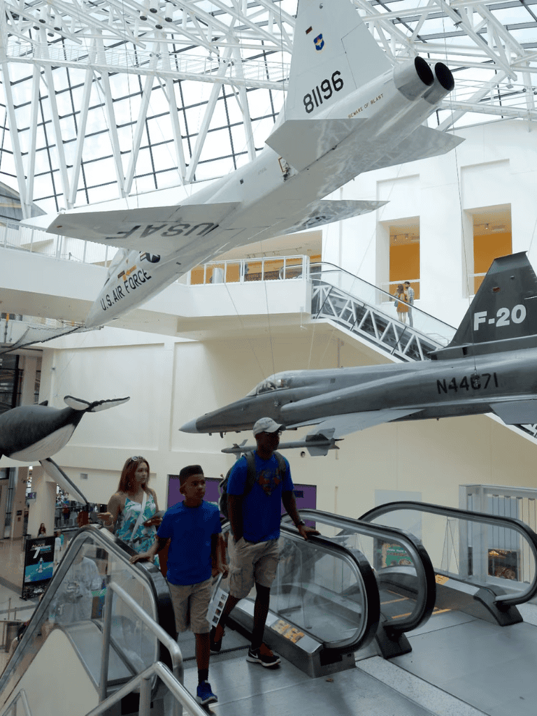 U.S. Air Force jet displays in an aviation museum with children exploring aircraft exhibits.