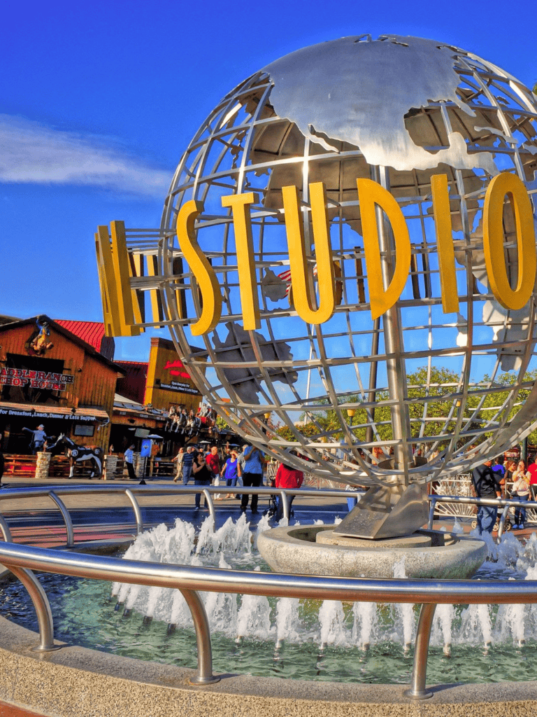 Bold QuestForDirections globe sculpture at studio entrance, promoting global travel and directions.