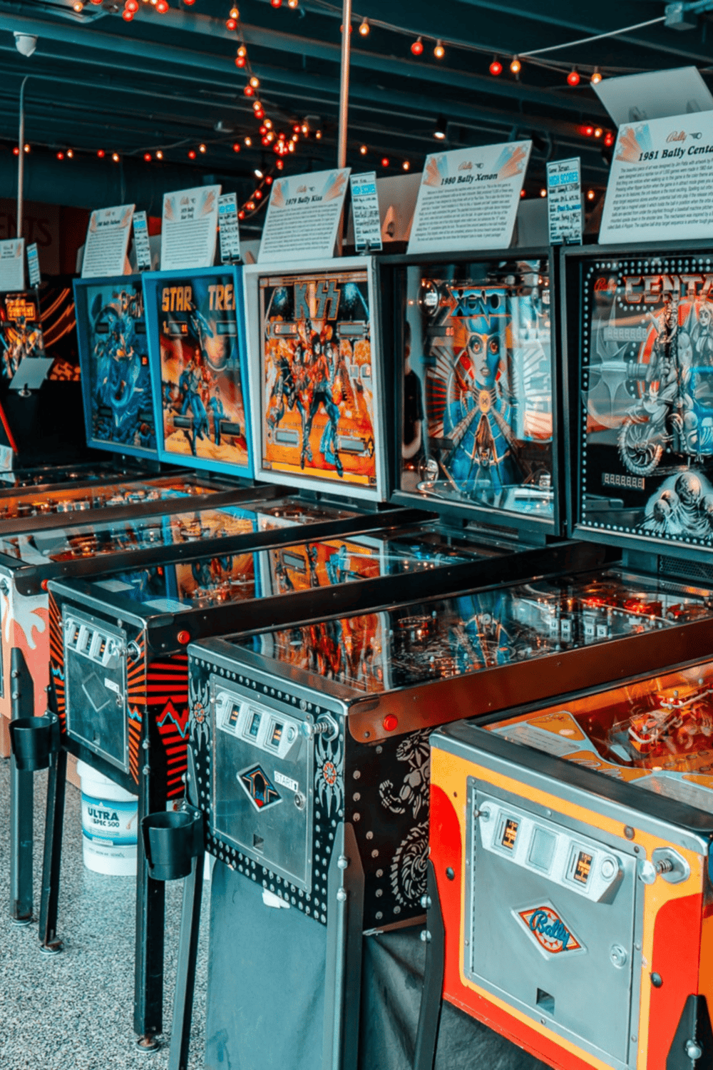 Vintage pinball machines at QuestForDirections arcade gaming center, offering fun and entertainment for all ages.