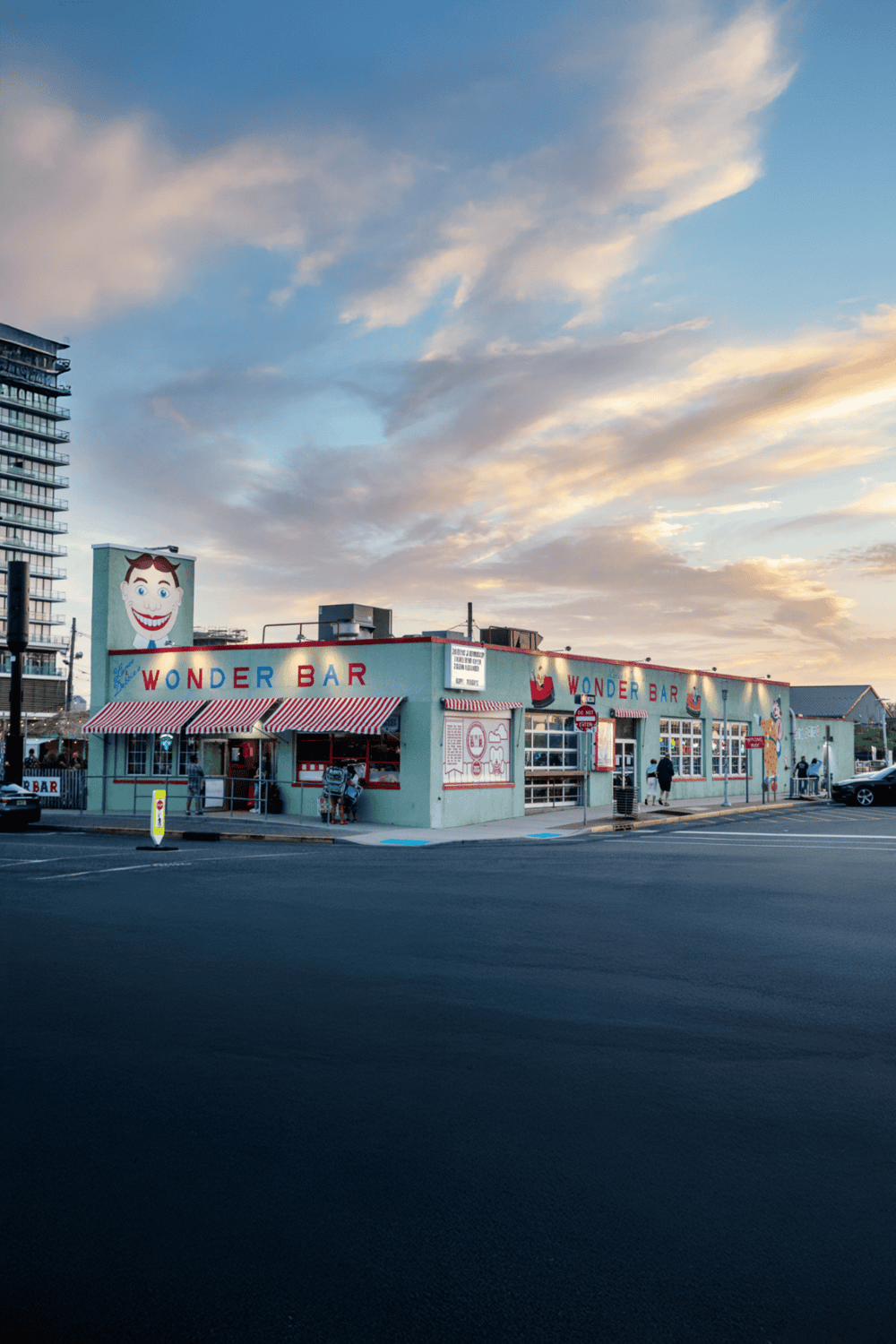 Brightly colored Wonder Bar restaurant in an urban setting, featuring retro signage and vibrant exterior design.