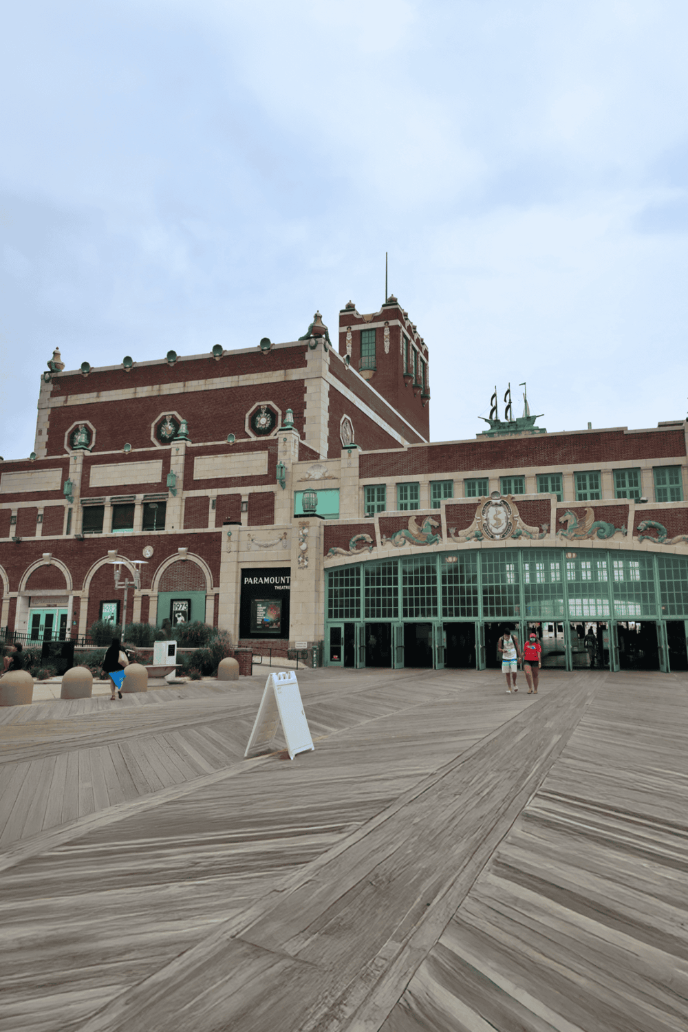 Historic movie theater exterior with Art Deco architecture and a wooden promenade deck.