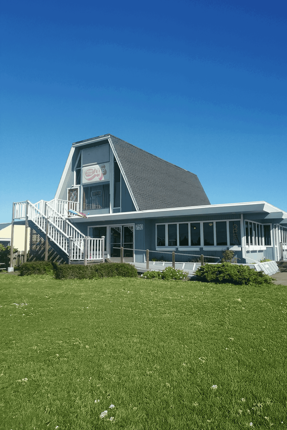 A-frame restaurant with ocean view and outdoor seating, perfect for dining and scenic views.