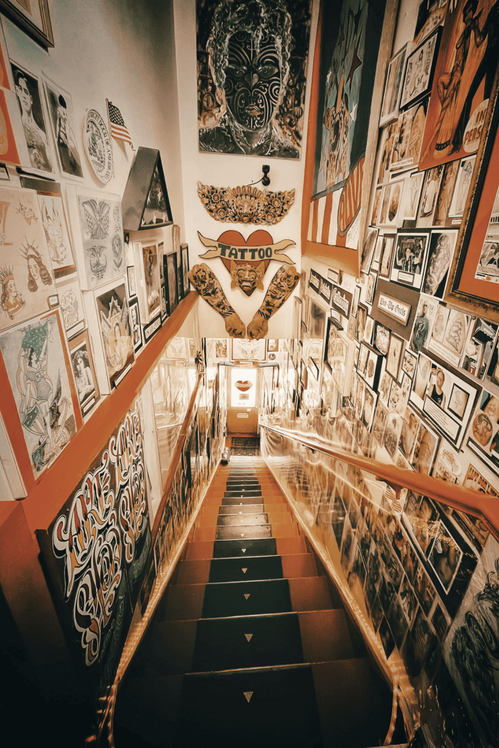 Colorful tattoo shop interior with framed artwork and murals, showcasing a creative and vibrant environment.