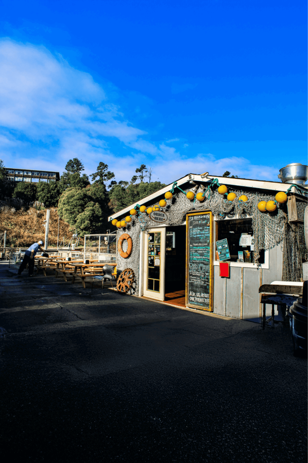 Cozy seaside restaurant with outdoor seating and nautical decor for memorable dining experiences.