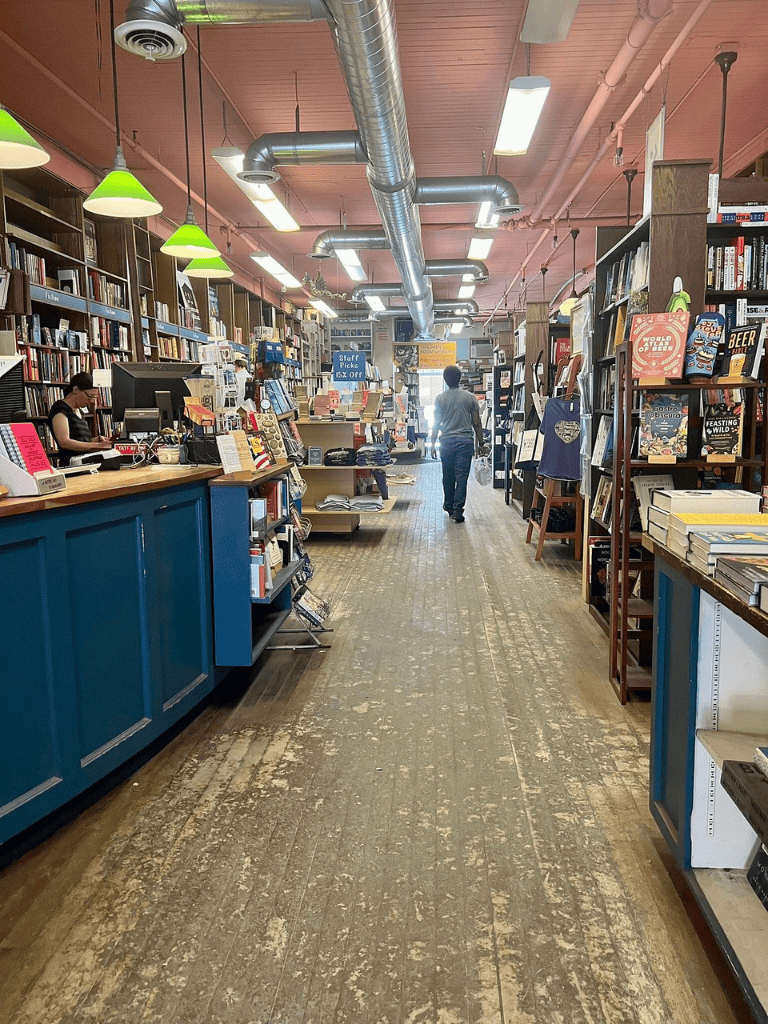 Bookshelf store interior with modern decor and vibrant lighting, ideal for book lovers and shoppers.