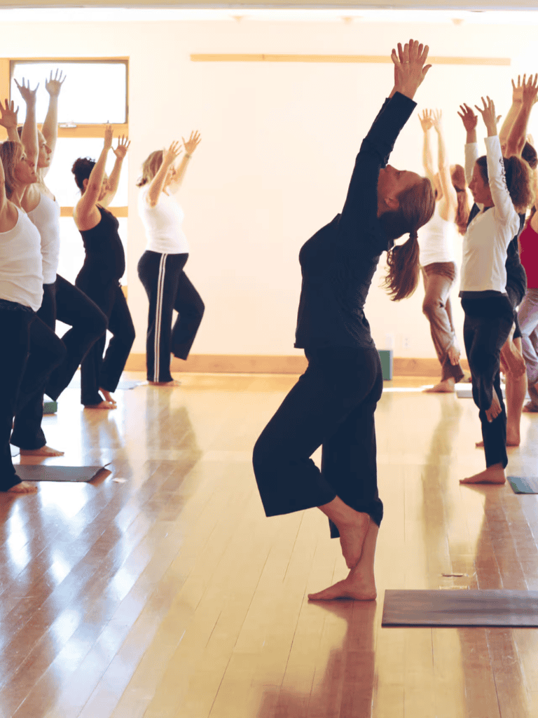 1. Yoga class with women practicing in a studio, focus on mindfulness and flexibility.