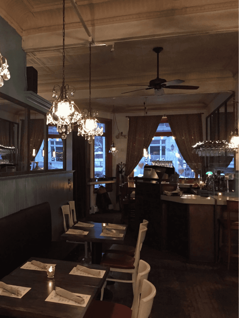 Charming vintage-style restaurant interior with elegant chandeliers and cozy ambiance.