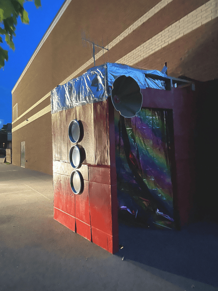 1. DIY cardboard rocket sculpture for space-themed event or decoration.