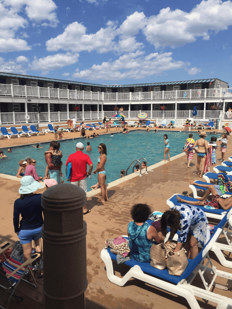 Relaxing pool area at QuestForDirections hotel with guests enjoying sunny day and vibrant atmosphere.