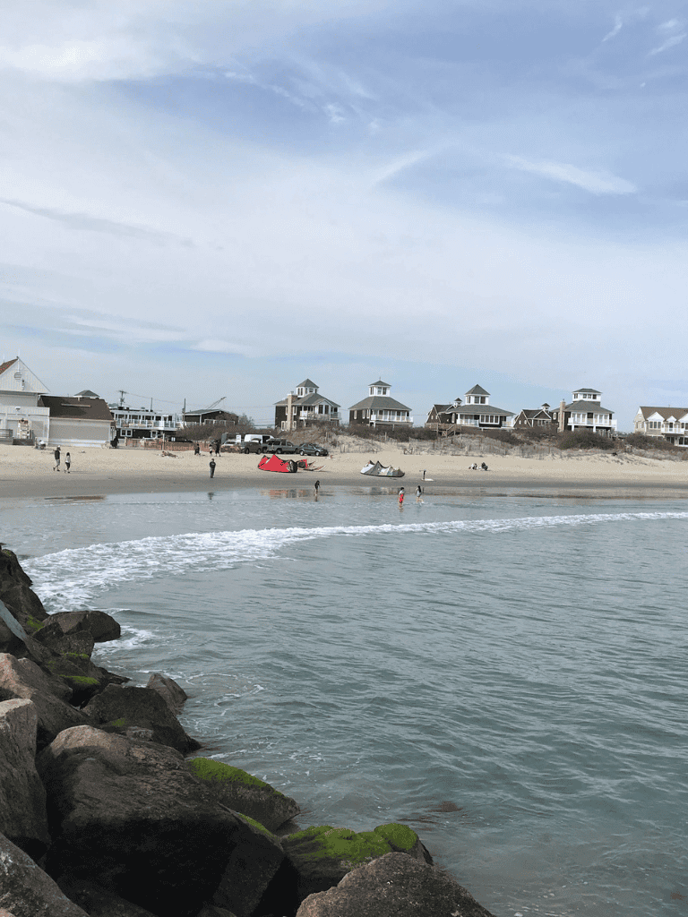 Bright beach with houses and boats, perfect for seaside adventures and relaxation.