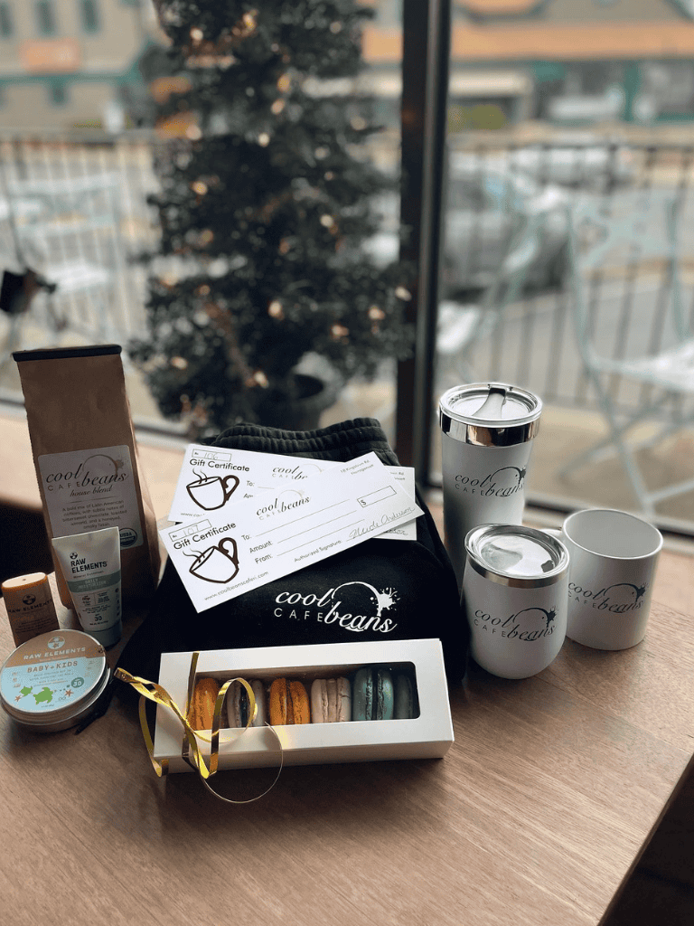 Delicious macaron assortment and coffee cups at Cool Beans Café, perfect for a cozy coffee break.