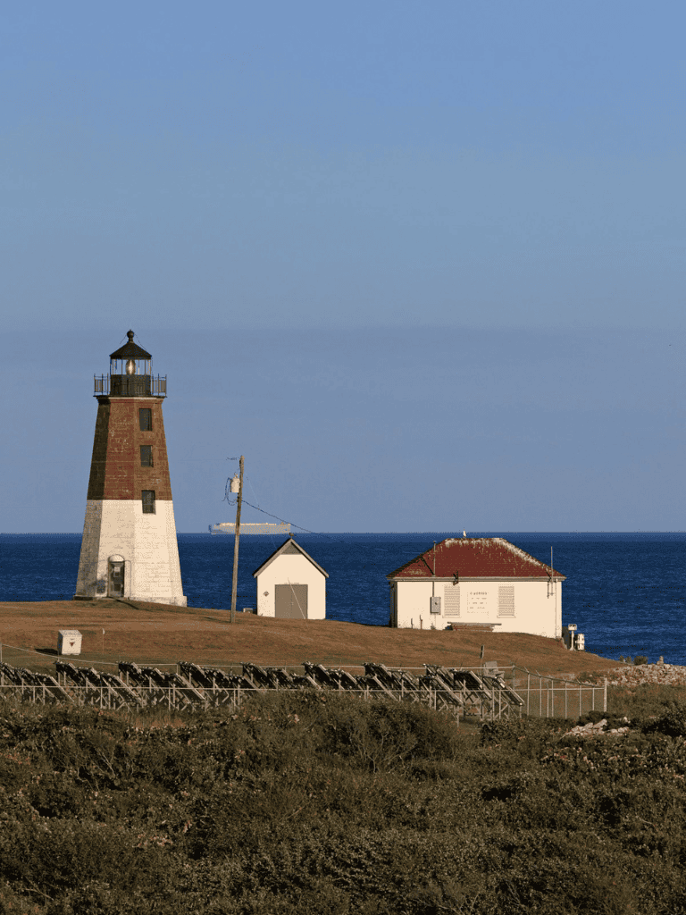 Historic lighthouse along the coast with ocean views, perfect for travel navigation and scenic photography.