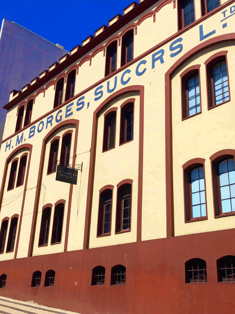 H.M. Borges building historic landmark in San Francisco with large blue sign.