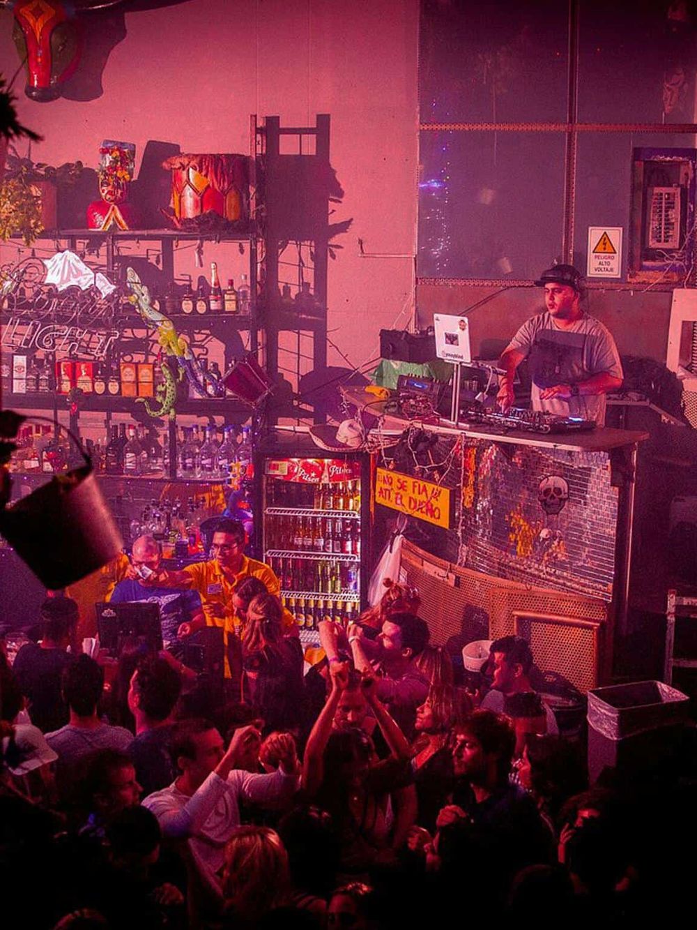 Vibrant nightclub scene with DJ, dancing crowd, and energetic party atmosphere at QuestForDirections.