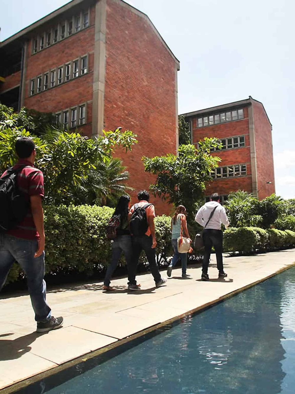 Modern academic building at Quest for Directions educational center with students walking outside.