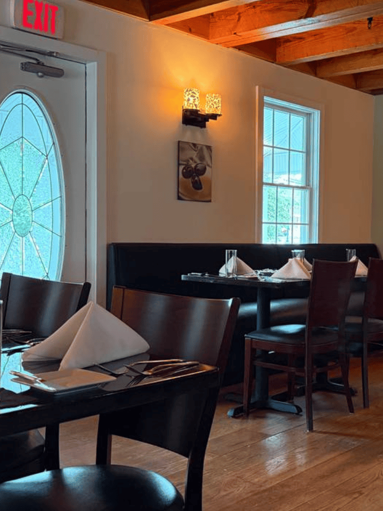 Elegant restaurant dining area with wooden accents and soft lighting, ready for guests.