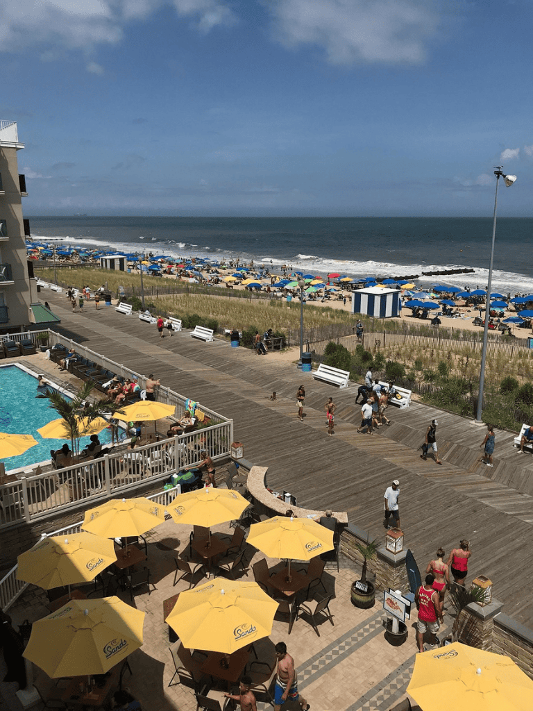 Vibrant beach scene with umbrellas, poolside, and ocean view at QuestForDirections.
