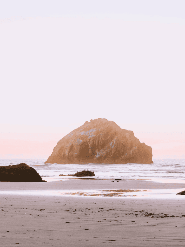 Rock formation at sunset on the beach, scenic coastal landscape, QuestForDirections.