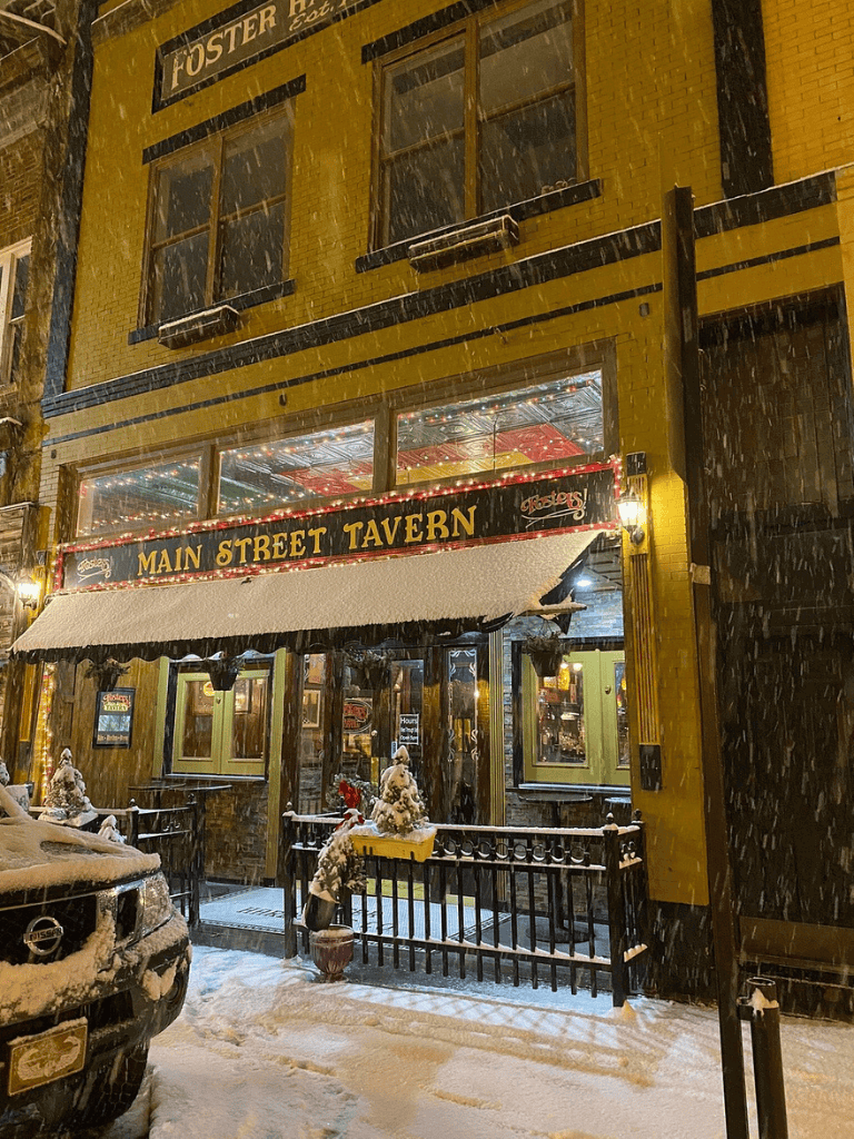Snowy night at Main Street Tavern, a popular pub for local nightlife and dining. Perfect spot for winter outings and celebrating special occasions.
