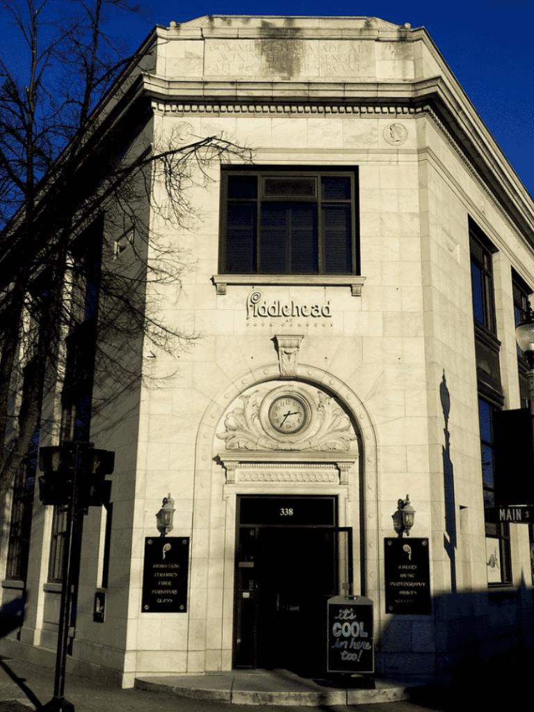 Aldehad Conference Center exterior with historic architecture and street signs in an urban setting.