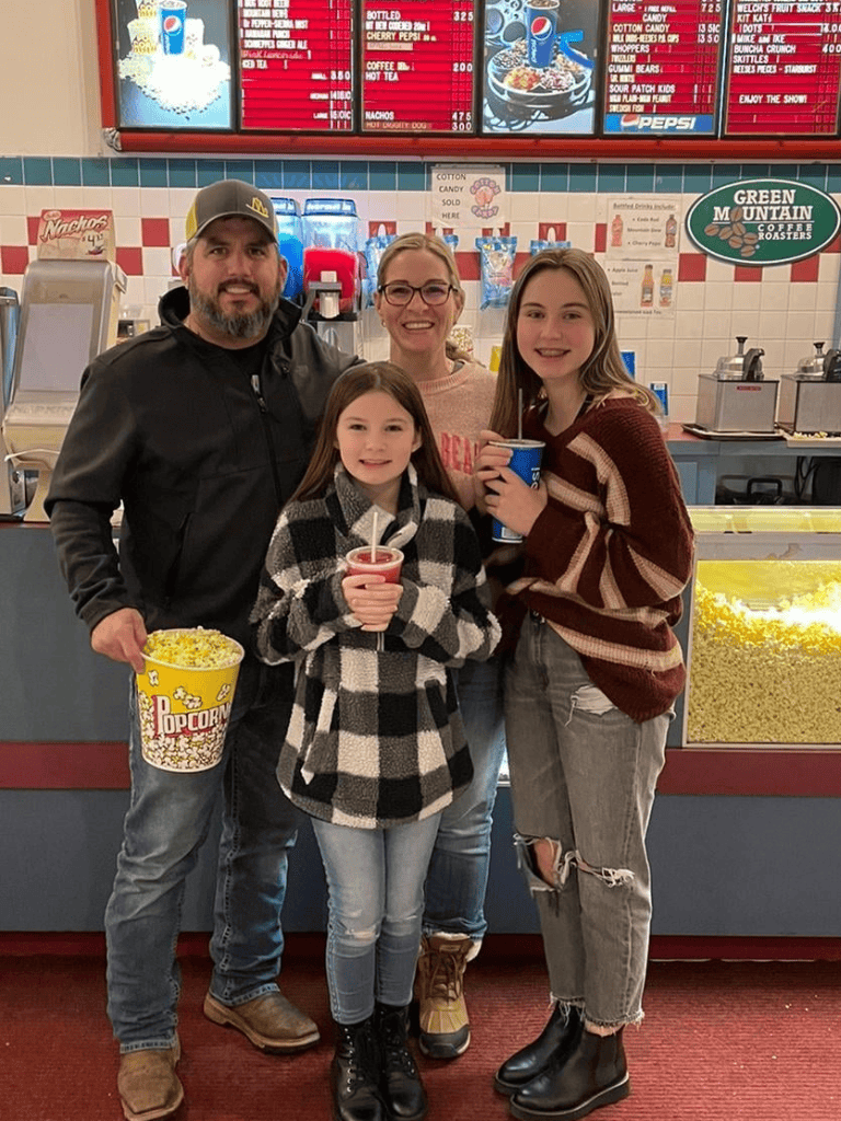 Enjoying classic movie snacks at QuestForDirections popcorn stand with family.