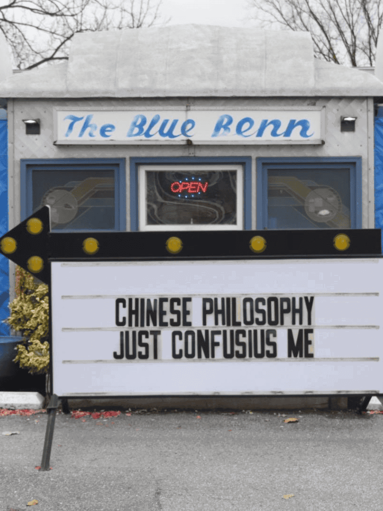 Chinatown restaurant sign with Chinese philosophy quote at The Blue Benn, casual dining.
