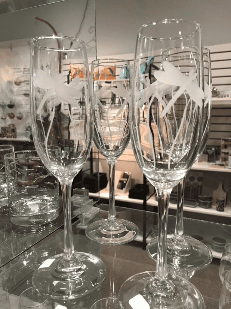 Elegant champagne flutes with white floral designs for special celebrations.