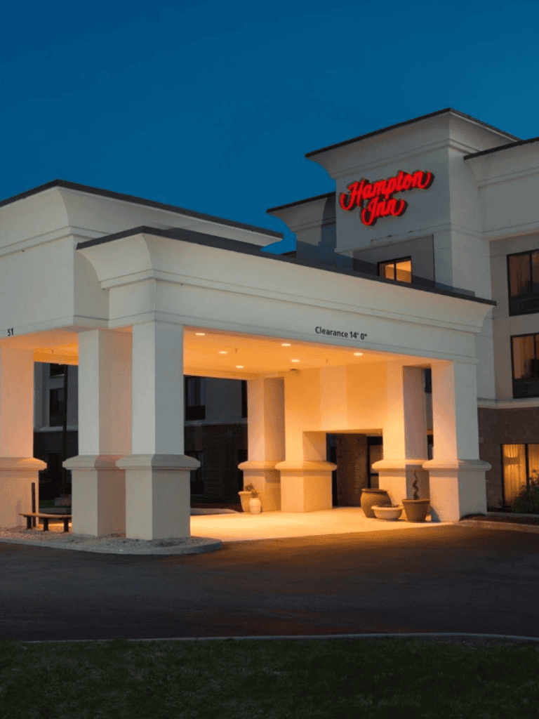 Modern Hampton Inn & Suites hotel entrance with inviting lighting and clean architecture near QuestForDirections.
