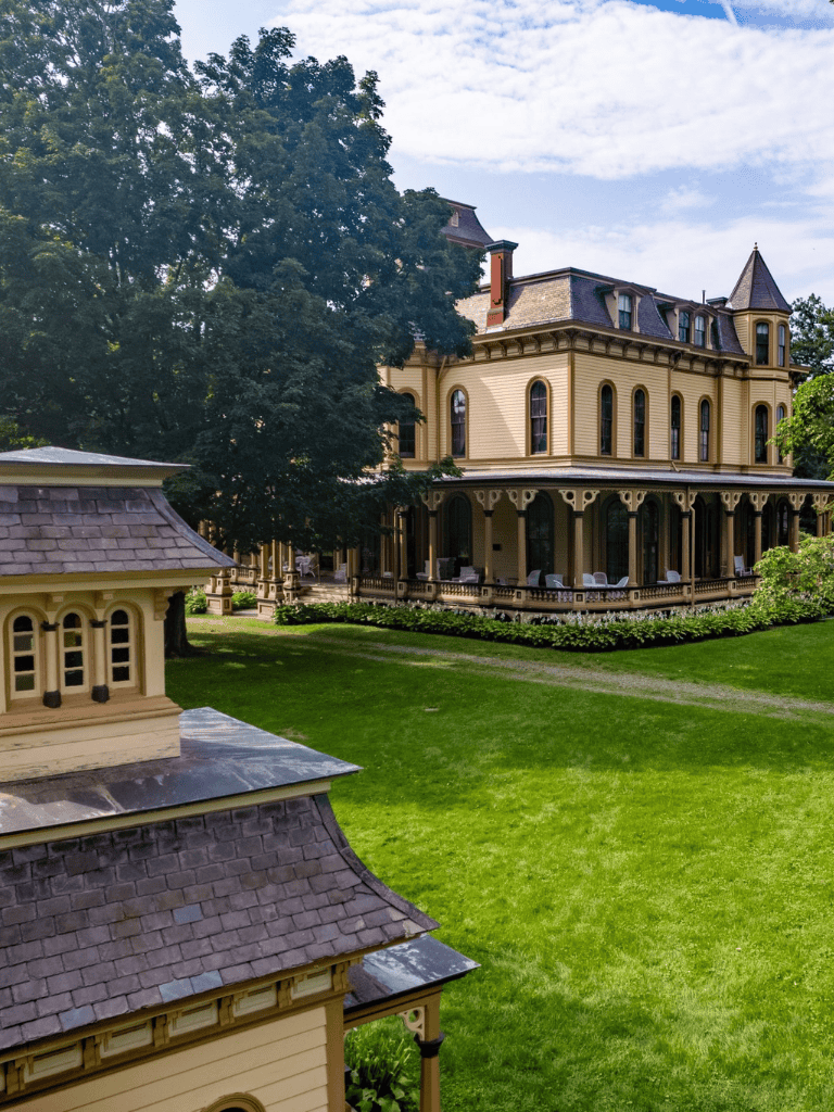 Imposing Victorian mansion with lush garden, perfect for luxury estate living.