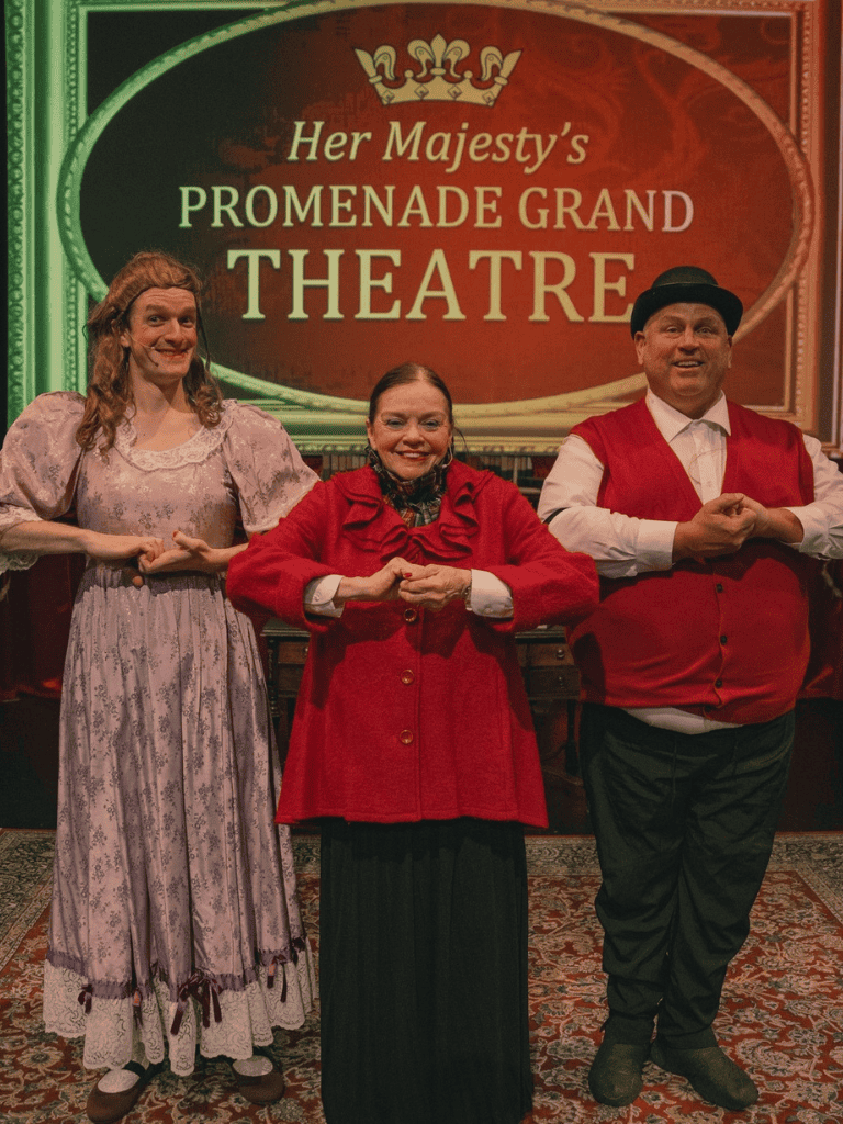 Victorian-era actors performing at Her Majesty's Promenade Grand Theatre event.
