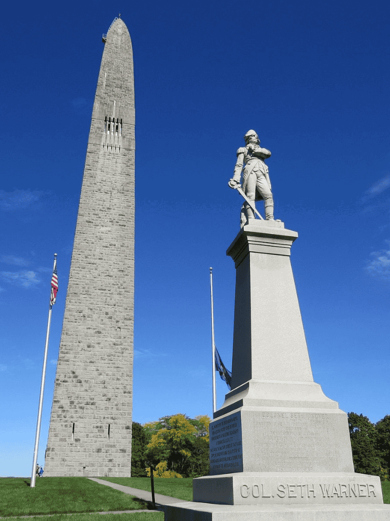Historic military monument with a tall obelisk and a soldier statue, representing American history and heritage.