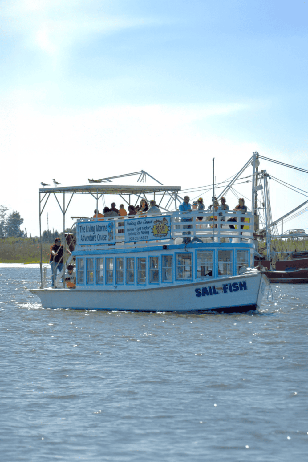 Boat tour on the water with passengers enjoying scenic maritime adventure.