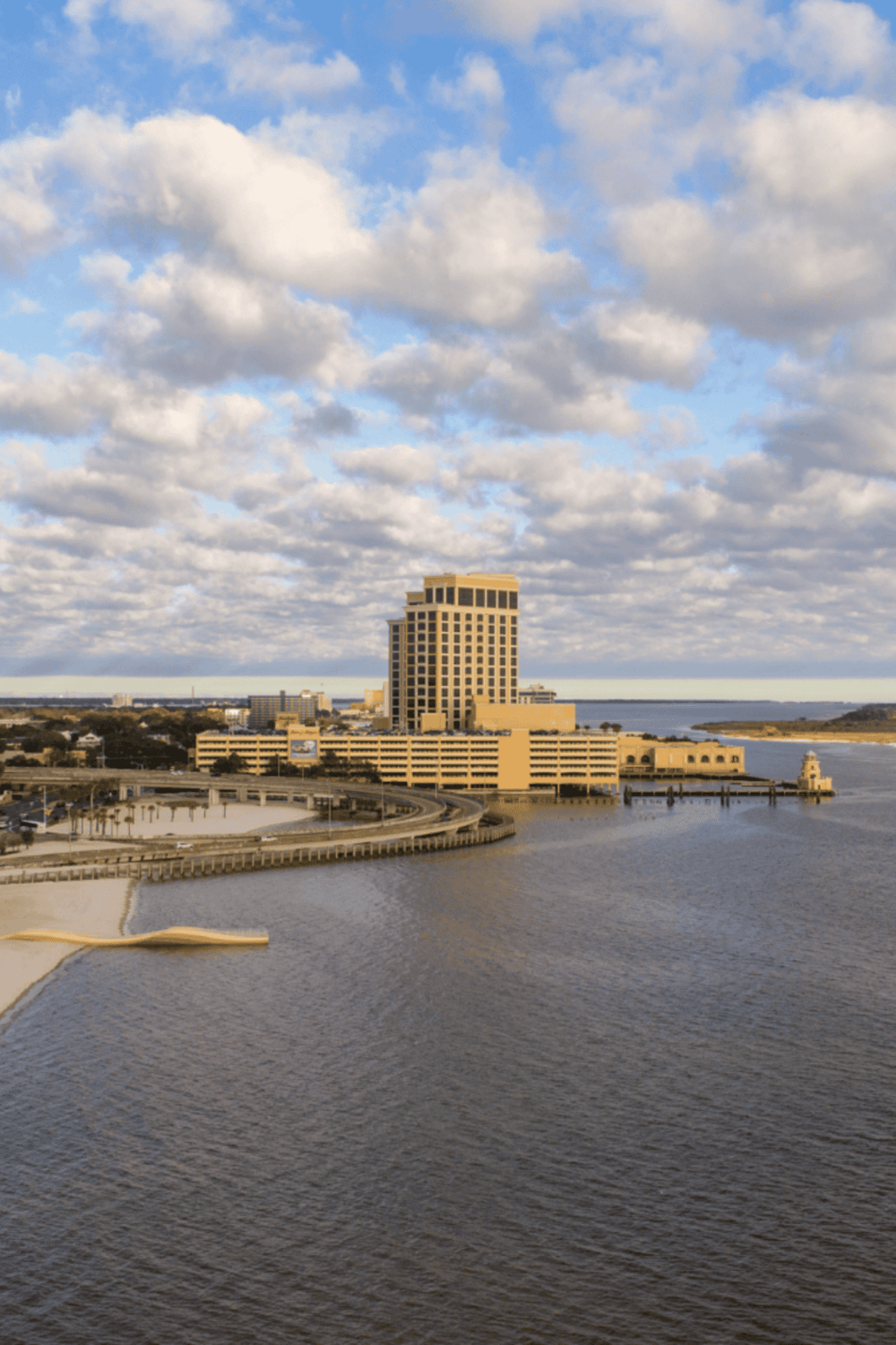 Modern waterfront cityscape with high-rise buildings and scenic water views.