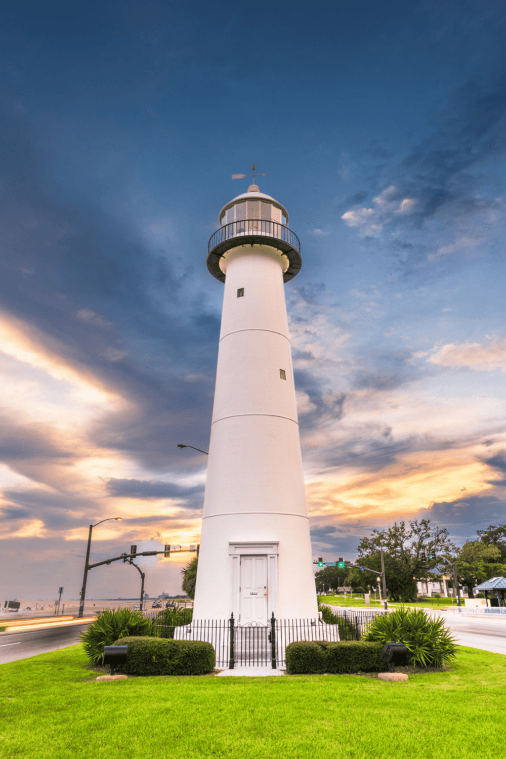 Lighthouse guiding travelers at popular navigation point with scenic sunset sky.