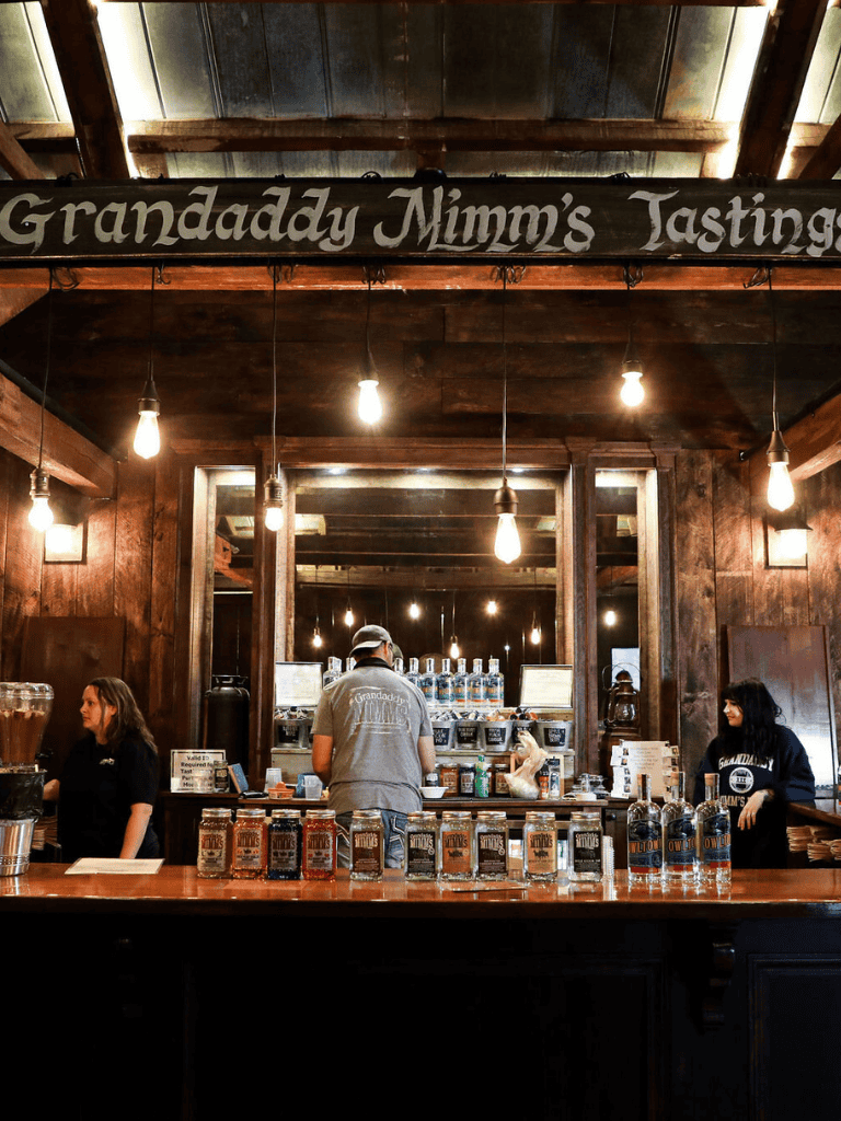 Handcrafted bourbon tastings at Granddaddy Mimms, rustic wooden bar, cozy tasting room ambiance.