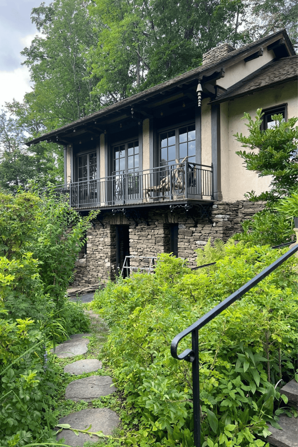Cozy cottage with stone foundation and lush garden, perfect for exploring at QuestForDirections.