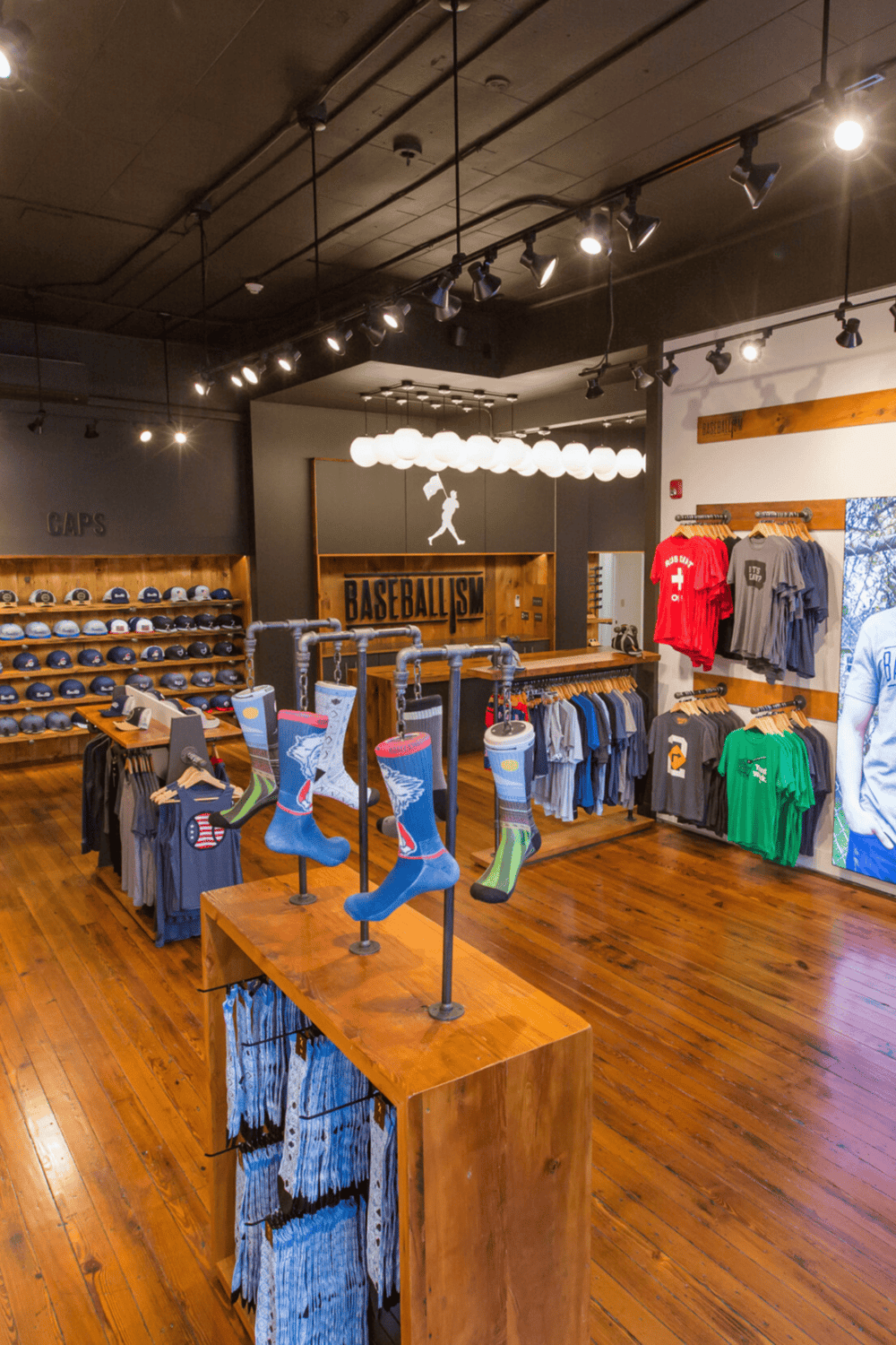 Vibrant baseball apparel and accessories display inside Quest for Directions store.