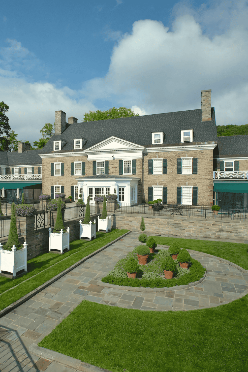 Elegant historic mansion with lush landscaped courtyard and wheelchair access, perfect for events and gatherings.