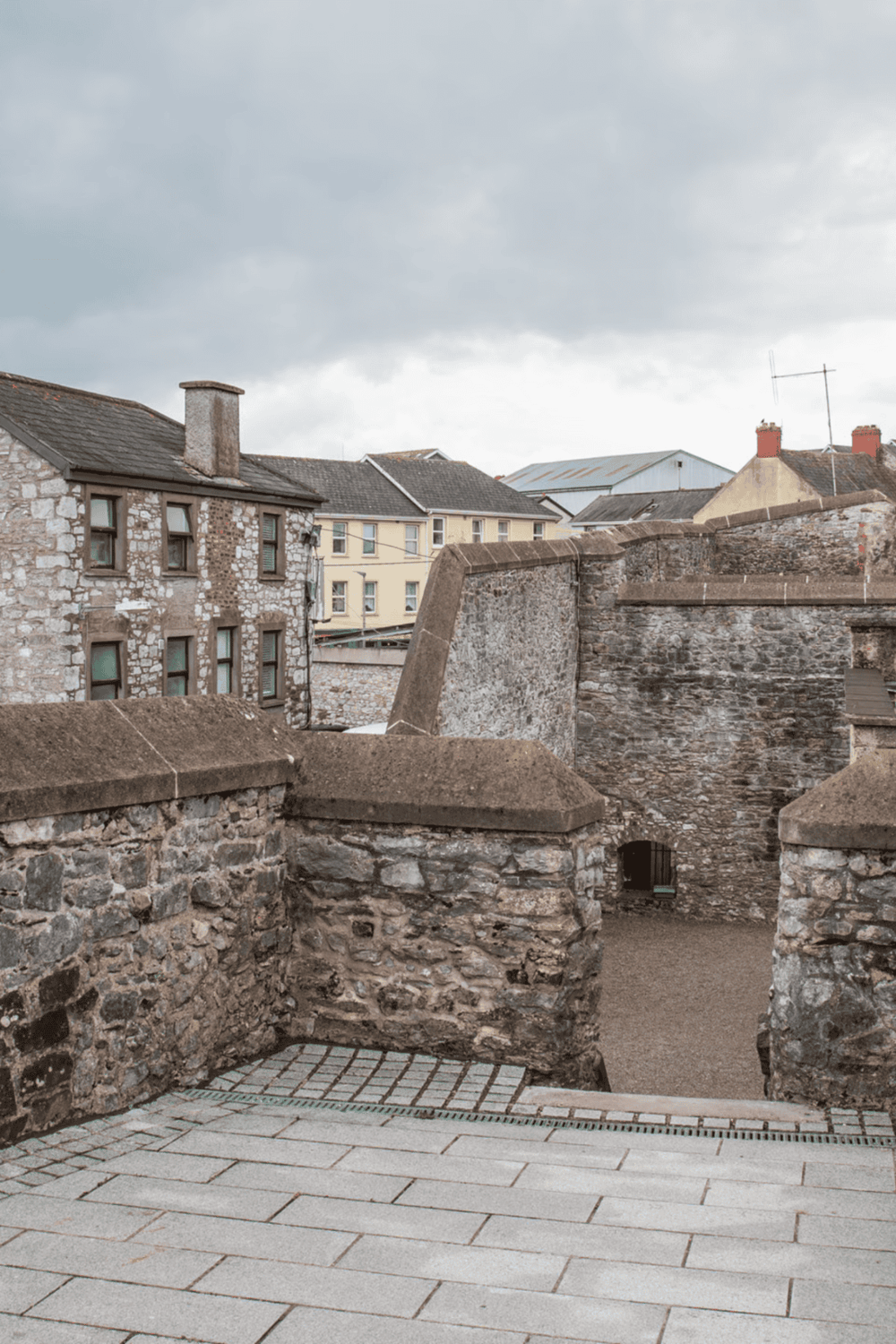 Historic stone city walls and buildings in Ireland, showing medieval architecture and scenic streets.