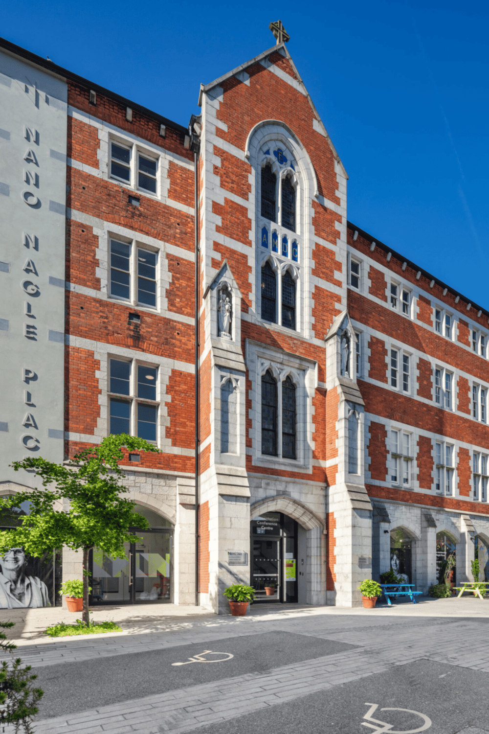 Historic Gothic-style Church building with red brick and white stone accents, located in downtown.